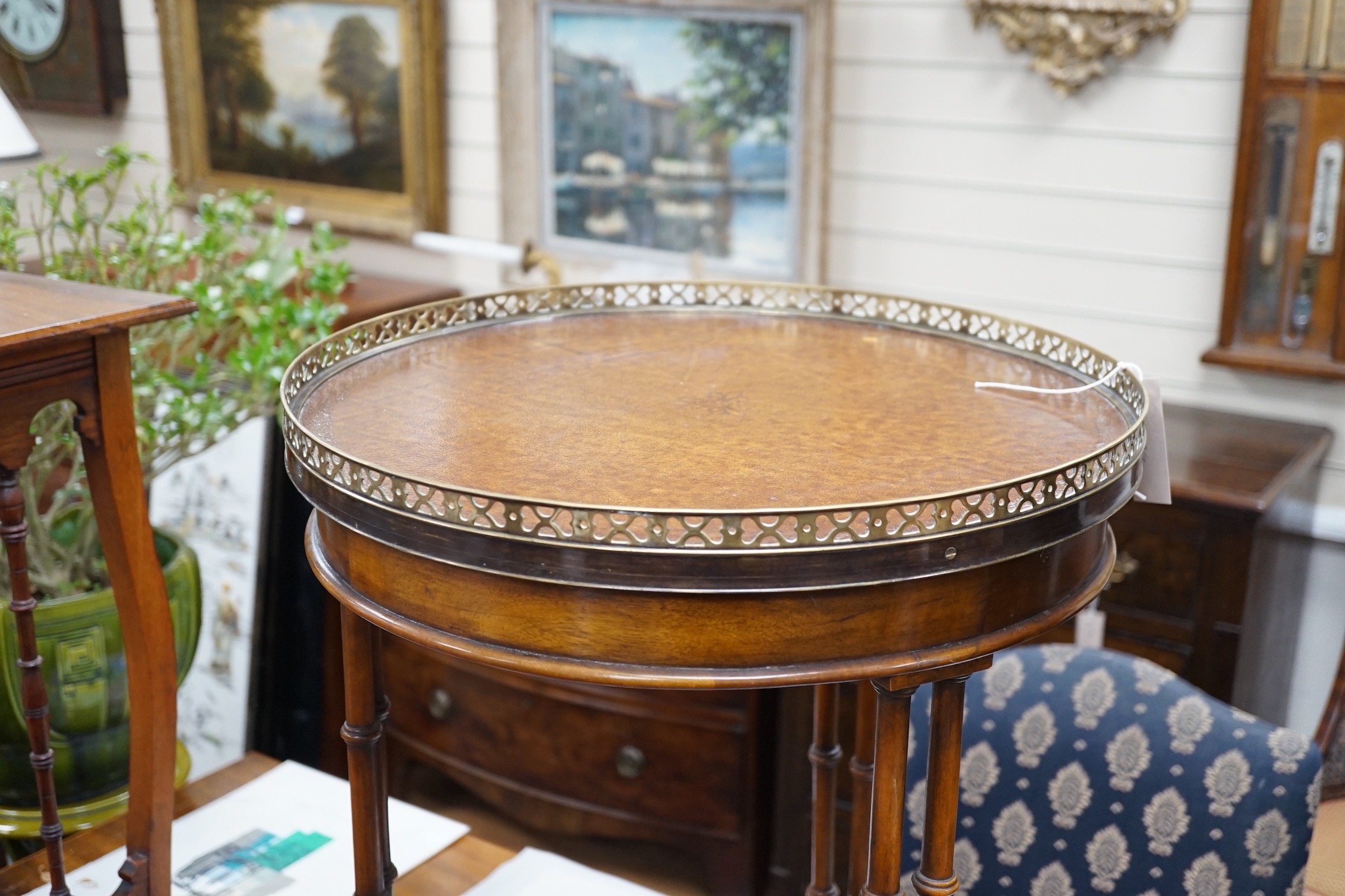 A leather topped mahogany occasional table with brass gallery, diameter 46cm *Please note the sale commences at 9am.